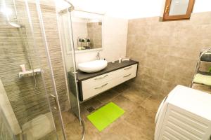 a bathroom with a sink and a shower at Apartments Andrea in Baška +37 photos