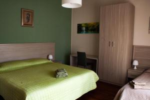 Postel nebo postele na pokoji v ubytování B&B Domus Benedicta