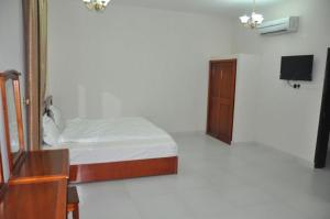 Cama o camas de una habitación en Al Sqlawi Hotel Apartments