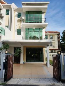 a large white building with a large entrance at De Nest Holiday home in Bayan Lepas
