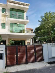 a house with a wooden gate in front of it at De Nest Holiday home in Bayan Lepas