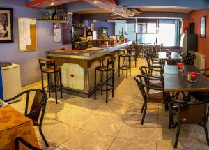 a bar in a restaurant with tables and chairs at Hotel Mabú in Ourense