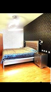 a bedroom with a bed and a night stand at Apartament Mamaia in Mamaia