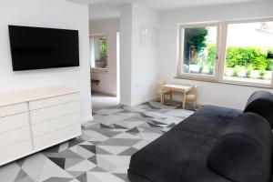 a living room with a tv and a couch at Villa UMA in Izola