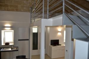 a living room with a staircase and a television at BRG APARTMENTS in Matera +93 photos