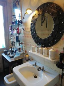a bathroom with a sink and a mirror at Villa Cécile in Ajaccio +16 photos