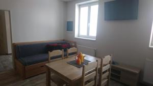 a living room with a table and a couch at Business apartmán in Žamberk