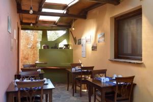 a restaurant with wooden tables and chairs in a room at Alkifron Hotel in Kala Nera