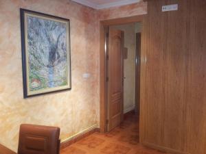 a room with a painting on the wall and a door at Alojamientos Río Cares in León