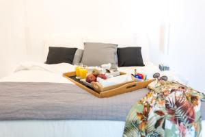 A bed or beds in a room at Dreaming View Suites