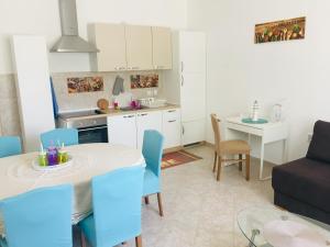 a kitchen and living room with a table and chairs at Villa Sole Tisno in Tisno