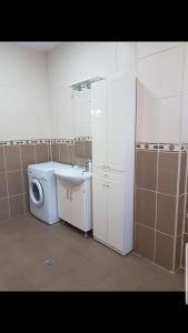 a bathroom with a washing machine and a sink at Apartament Mamaia in Mamaia +48 photos
