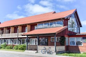 a red brick building with a red roof at Zunda in Nida