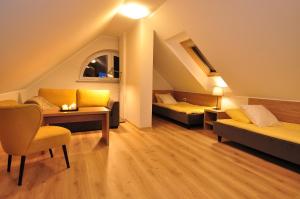 a room with two beds and a table and a couch at Piaskowy 2 in Jantar