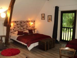 a bedroom with a bed and a brick wall at La maison du rocher in Carennac
