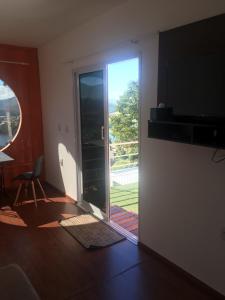 a living room with a sliding glass door with a view at Amsterdam lofts 3 in Poços de Caldas