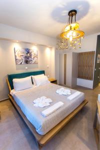 a bedroom with a large bed with towels on it at Moonline Maisonettes & Apartments in Parga