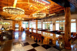 a dining room with a long table and chandeliers at Full Moon Spa in Wulai