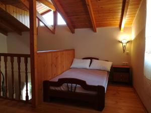 a bedroom with a bed in a room with wooden ceilings at Plataniotissa Mansion in Kalavrita