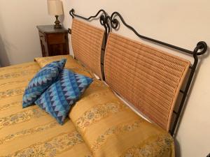 a bed with two pillows on top of it at Agriturismo Benza in Imperia