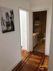a bathroom with a toilet and a picture on the wall at Apartment near the airport in Lisbon