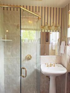 a bathroom with a sink and a shower at Churchill Manor in Napa