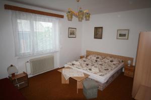 a bedroom with a bed and a table in it at Ubytování v Proseči in Proseč