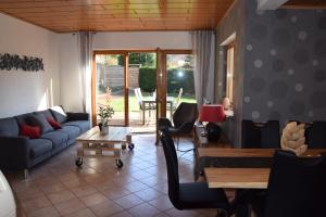 a living room with a couch and a table at L'Ours Vert in Baerenthal