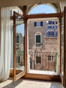an open window with a view of a building at Canaletto Apartments in Venice