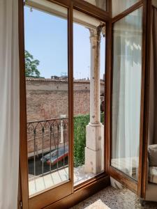 a glass door with a view of a balcony at Canaletto Apartments in Venice