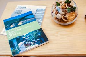 a book and a bowl of food on a table at Alo BnB 5 - Near NIPPORI, SENDAGI, YANAKA GINZA - Self check-in in Tokyo