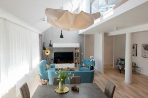 a living room with a blue couch and a table at Millennium apartments in Čakovec