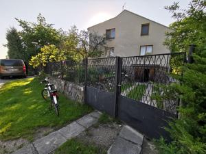 a bike parked next to a fence in front of a house at Apartmán in Dolní Bukovsko