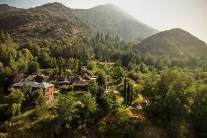 an aerial view of a house in a valley with mountains at Hotel Altiplanico Cajón del Maipo in San José de Maipo