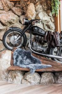 a motorcycle parked next to a stone wall at Vötter's Hotel in Kaprun