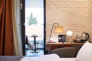 a bedroom with a bed and a desk and a deskablish at Livris Hotel in Zagreb