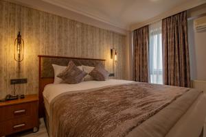a bedroom with a large bed and a window at Avrasya Port Hotel in Istanbul
