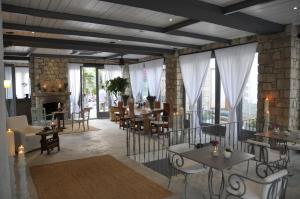 a restaurant with tables and chairs and a fireplace at Alaçatı Ala Hotel - Special Category in Alaçatı