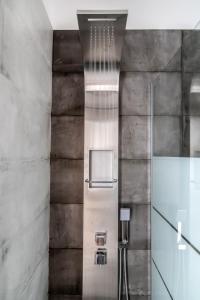 a bathroom with a shower with a glass door at Lux 'n Comfort Apartments in Tinos +97 photos