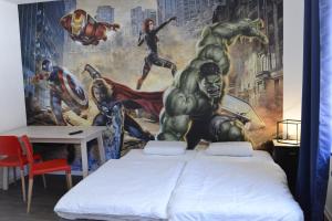 a bedroom with a superhero mural on the wall at Pforzheim Ferienhaus in Pforzheim