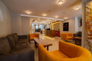 a living room with a couch and a table and chairs at Avrasya Port Hotel in Istanbul
