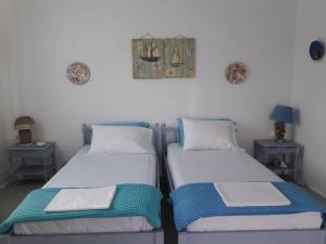 two beds sitting next to each other in a room at Sikinos Best View in Alopronia