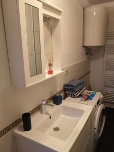 a bathroom with a white sink and a mirror at Apartmani Manda in Omišalj +12 photos