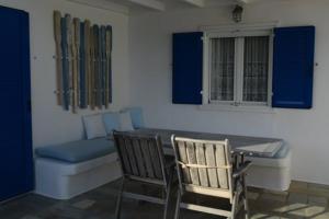 a room with a table and chairs and a couch at Sikinos Best View in Alopronia +72 photos