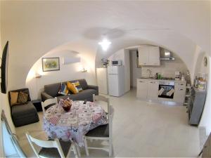 a kitchen and a living room with a table in a room at Landolina Sweet Home in Catania