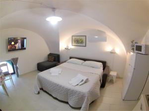 a bedroom with a bed with towels on it at Landolina Sweet Home in Catania