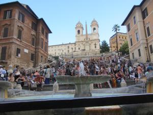 a crowd of people sitting around a fountain at Stay In Rome in Rome