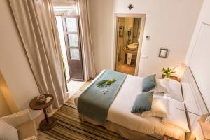 a bedroom with a large bed with blue pillows at Balcón de Córdoba in Córdoba +86 photos