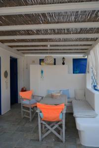 a dining room with a table and chairs at Sikinos Best View in Alopronia