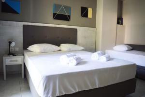 A bed or beds in a room at Enjoy Apartments & Studios